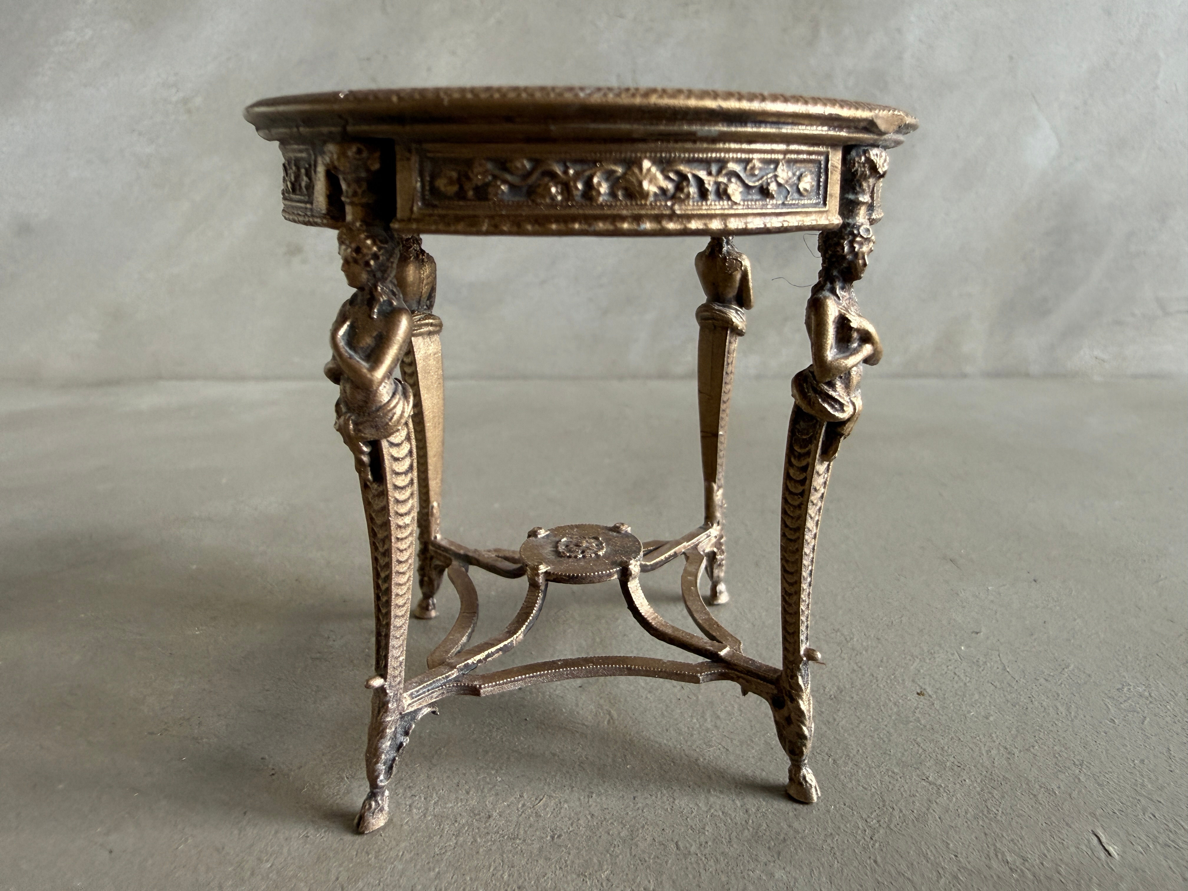 AF16 - rOUND CARYATID TABLE WITH SLIGHT NICK IN THE RIM OF THE TABLE TOP