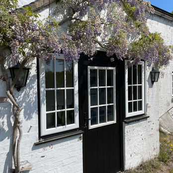 Solidor 'Beeston' composite door in Black with contrasting White framework, Astragal Bar Glass design and Black Cottage handles with side windows to match. You want - we can make it happen !