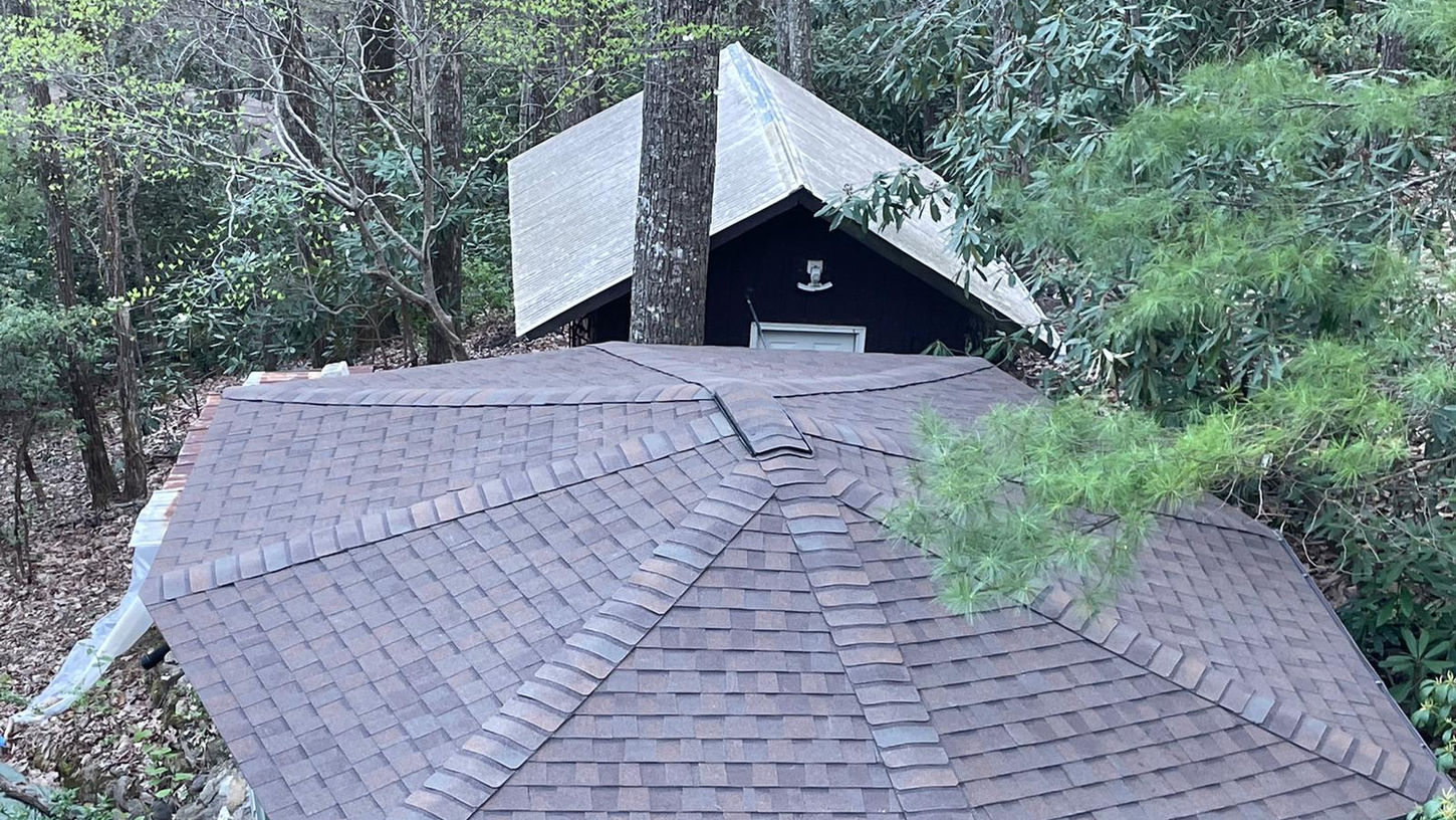 Elevate the beauty and protection of your Black Mountain, NC rotunda home with our premium asphalt shingle roof replacement services. Our skilled roofing professionals specialize in preserving the unique architectural features of rotunda homes while delivering exceptional durability and performance.

With meticulous attention to detail and the use of top-quality materials, we ensure a seamless roof replacement process that enhances both aesthetics and functionality. Safeguard your home against the unpredictable North Carolina weather with our reliable asphalt shingles, designed to withstand wind, rain, and UV exposure.

Our experienced team is committed to providing a stress-free experience, minimizing disruptions to your daily life. We take pride in delivering exceptional craftsmanship, leaving you with a beautiful, long-lasting roof that complements the distinct character of your rotunda home.

Trust our locally based experts for your asphalt shingle roof replacement needs in Black Mountain, NC. Contact us today to schedule a personalized consultation and take the first step towards enhancing your rotunda home's curb appeal and protection.