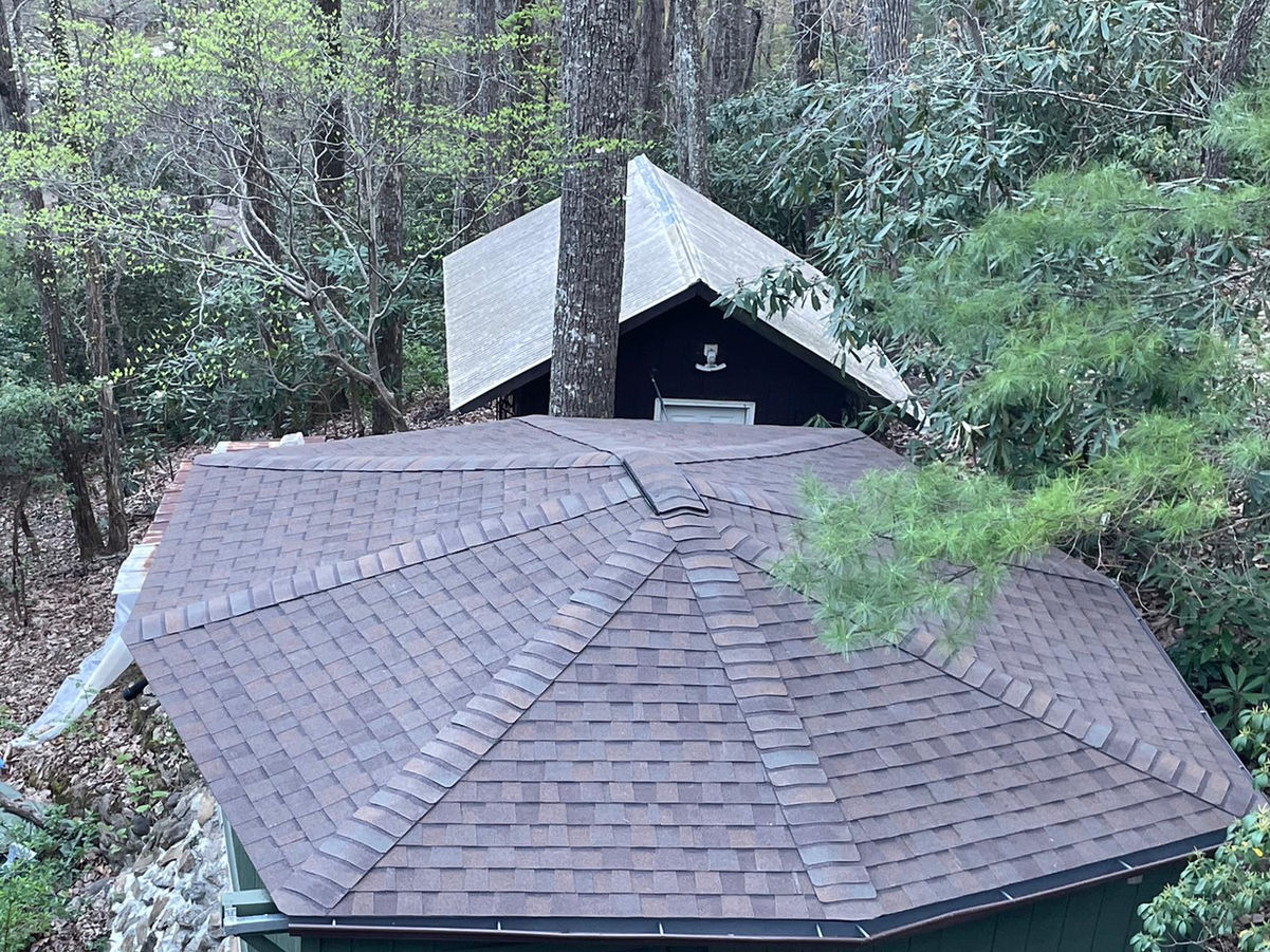 Elevate the beauty and protection of your Black Mountain, NC rotunda home with our premium asphalt shingle roof replacement services. Our skilled roofing professionals specialize in preserving the unique architectural features of rotunda homes while delivering exceptional durability and performance.

With meticulous attention to detail and the use of top-quality materials, we ensure a seamless roof replacement process that enhances both aesthetics and functionality. Safeguard your home against the unpredictable North Carolina weather with our reliable asphalt shingles, designed to withstand wind, rain, and UV exposure.

Our experienced team is committed to providing a stress-free experience, minimizing disruptions to your daily life. We take pride in delivering exceptional craftsmanship, leaving you with a beautiful, long-lasting roof that complements the distinct character of your rotunda home.

Trust our locally based experts for your asphalt shingle roof replacement needs in Black Mountain, NC. Contact us today to schedule a personalized consultation and take the first step towards enhancing your rotunda home's curb appeal and protection.