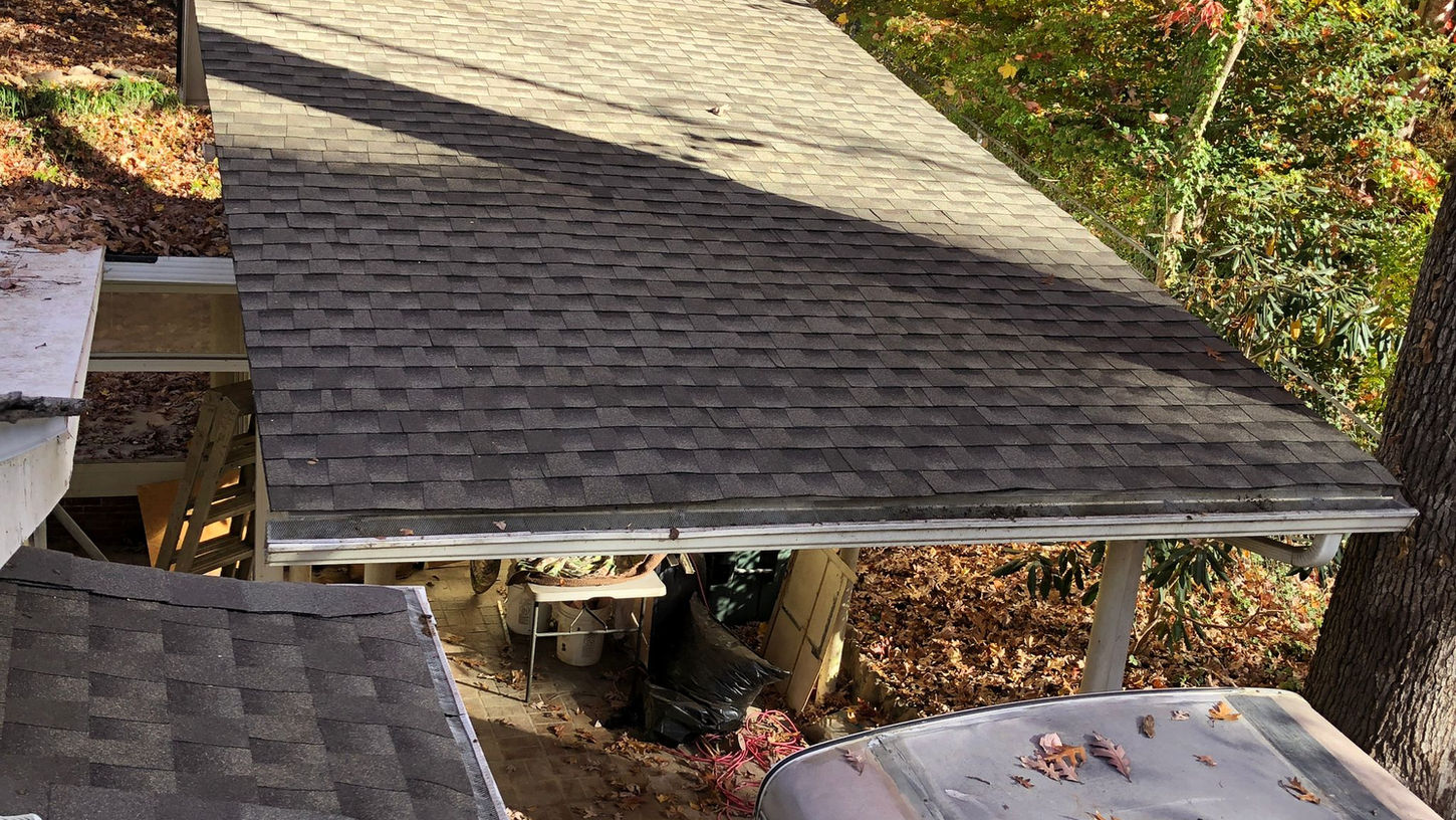 Professional asphalt shingle roof installation on a house in Black Mountain, NC. Enhance the beauty and durability of your home with our expert roofing services.