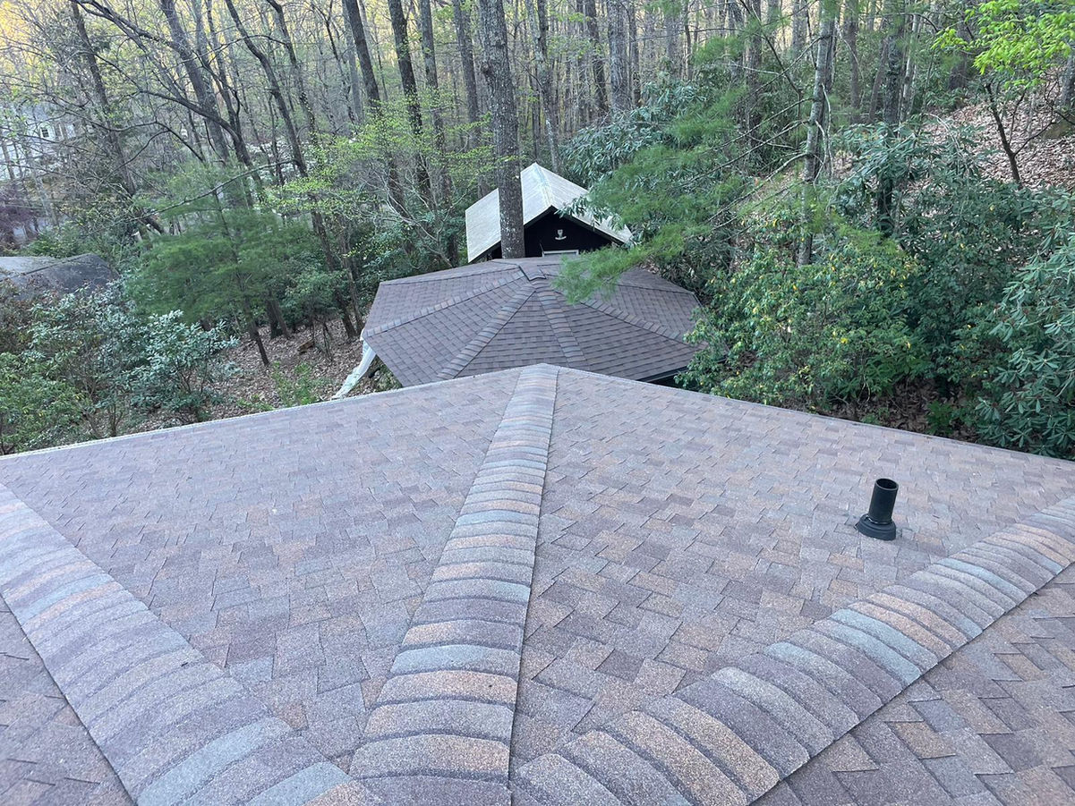 Elevate the beauty and protection of your Black Mountain, NC rotunda home with our premium asphalt shingle roof replacement services. Our skilled roofing professionals specialize in preserving the unique architectural features of rotunda homes while delivering exceptional durability and performance.

With meticulous attention to detail and the use of top-quality materials, we ensure a seamless roof replacement process that enhances both aesthetics and functionality. Safeguard your home against the unpredictable North Carolina weather with our reliable asphalt shingles, designed to withstand wind, rain, and UV exposure.

Our experienced team is committed to providing a stress-free experience, minimizing disruptions to your daily life. We take pride in delivering exceptional craftsmanship, leaving you with a beautiful, long-lasting roof that complements the distinct character of your rotunda home.

Trust our locally based experts for your asphalt shingle roof replacement needs in Black Mountain, NC. Contact us today to schedule a personalized consultation and take the first step towards enhancing your rotunda home's curb appeal and protection.