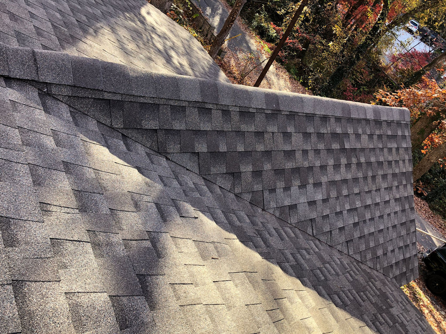 Professional asphalt shingle roof installation on a house in Black Mountain, NC. Enhance the beauty and durability of your home with our expert roofing services.