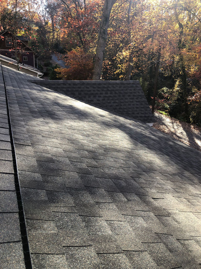 Professional asphalt shingle roof installation on a house in Black Mountain, NC. Enhance the beauty and durability of your home with our expert roofing services.