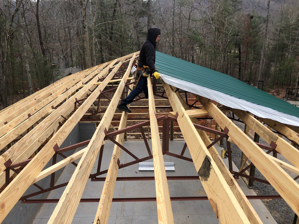 Professional installation of galvanized metal roof, fascia, and soffit on a house in Black Mountain, NC. Enhance your home's durability and aesthetics with our expert roofing services.