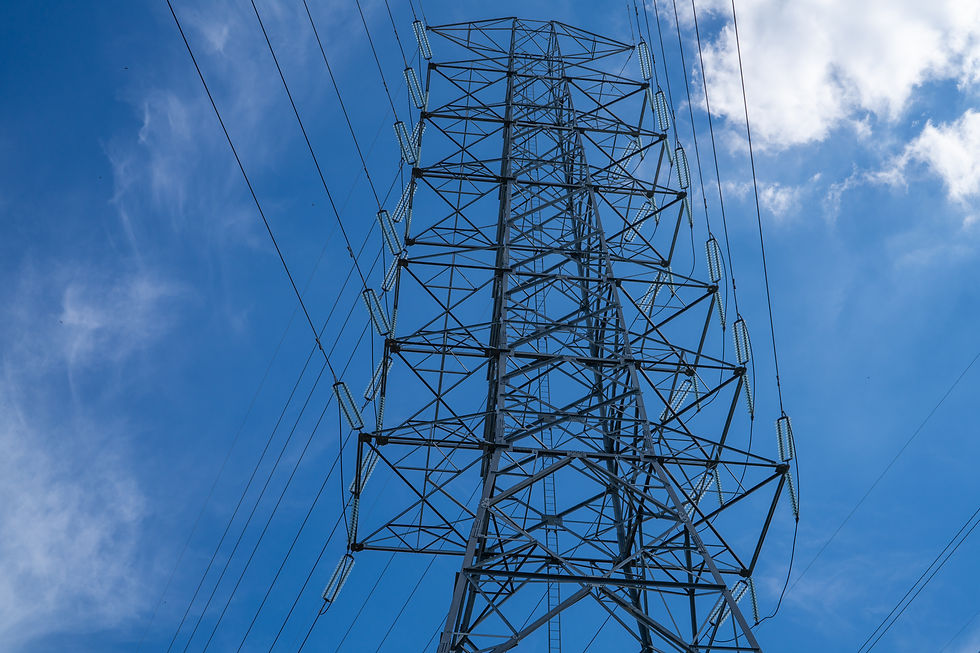 High voltage electrical transmission tower infrastructure delivers essential power across national grid system during peak energy demand showcasing critical utility distribution network