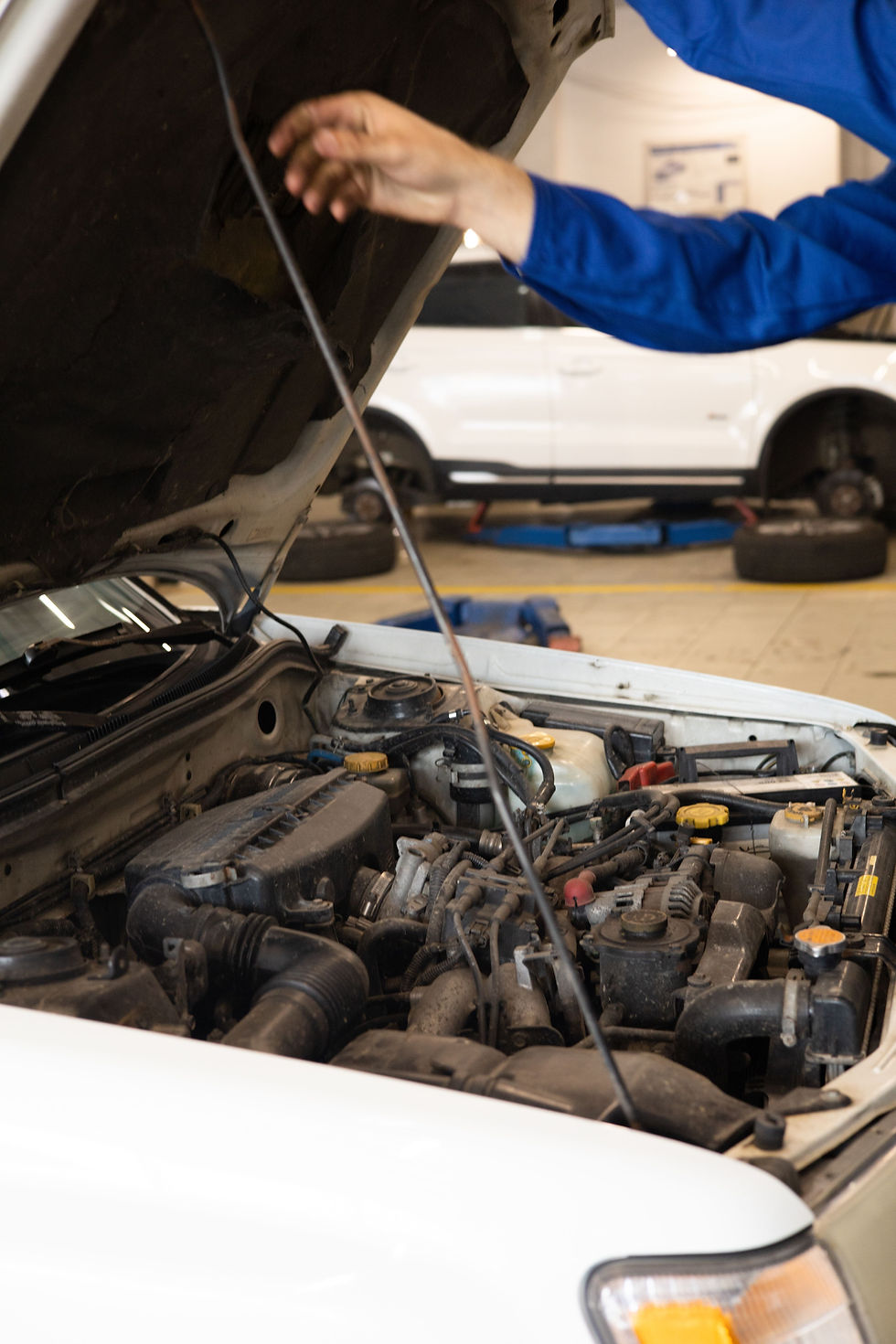 Mechanic inspecting a vehicle engine for diesel performance