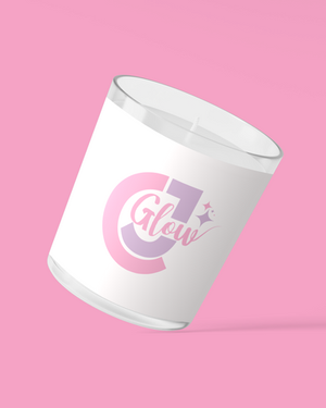 a candle with the word glow on it
