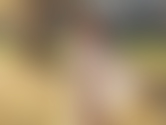 A woman with her arms out, looking up with eyes closed and at peace.