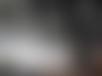 Winter landscape of dormant trees surrounded by smoke from a bonfire.