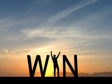 Person jumping between the letters "W" and "N"