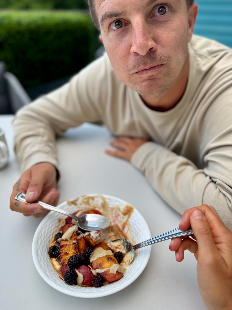 couple enjoying grilled + spiced peaches with tahini, maple syrup and Greek yoghurt