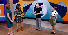 four people standing on daytime talkshow set