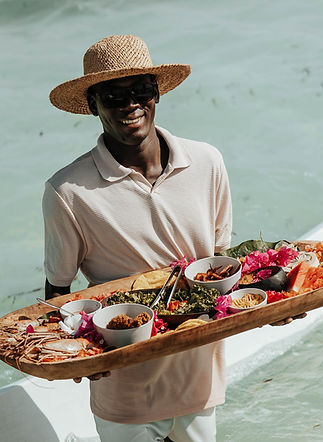 staff delivering a serving of delicious seafood platter to you on the gypsea