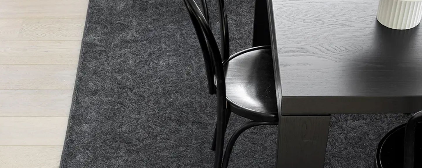 A dining rug on a wooden floor defining the dining space