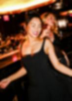 woman dancing at DJ event in rooftop bar in NYC