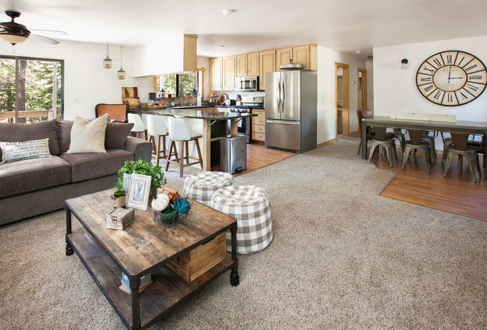 Gorgeous open living, dining, and kitchen area with a deck. New flooring added to the kitchen, living room, dining room and hallway! 