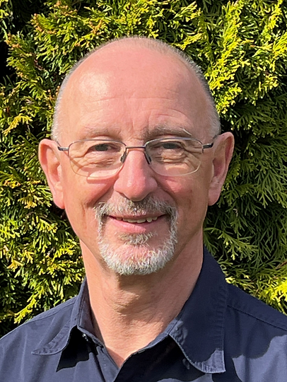 Ralph Tietjen in front of greenery.