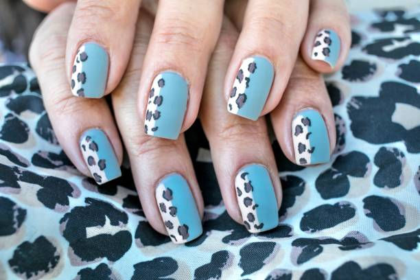 Hands with matte blue leopard print nails