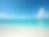 A serene-beach-landscape-with-clear-turquoise-water-and-white-sand-beach-under-a-bright-bl