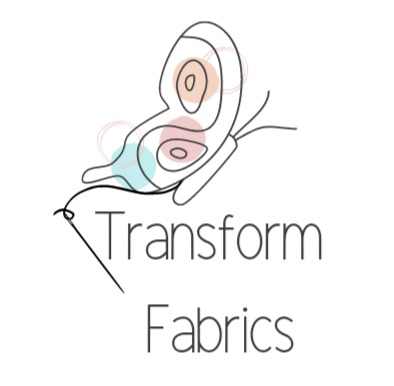 Transform Fabrics logo. It is a thin outline of a butterfly with light blue, light pink and a yellow or orange series of spots used in the background of the butterfly's wings and body to add colour. There is a needle and thread coming from the join of the butterfly's wings and body that almost make it look like the butterfly has been stitched. Below the butterfly are the words Transform Fabrics