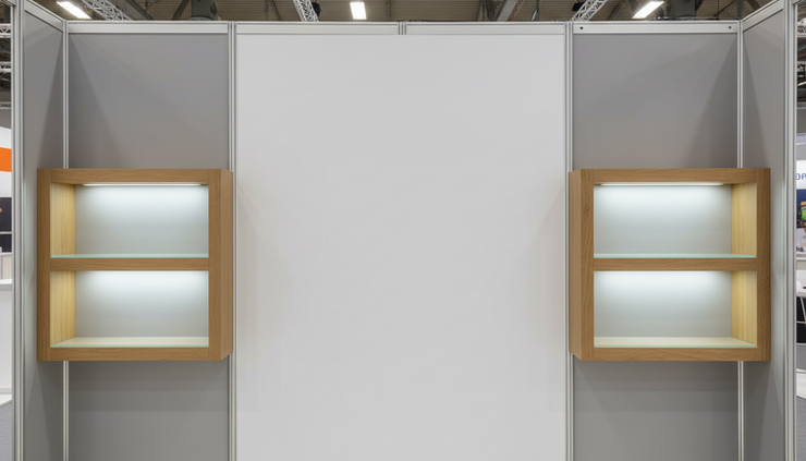 Close-up view of a clean exhibition wall with one large graphic area and integrated product shelves.