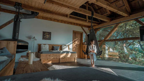 Light-filled alpine bedroom with freestanding bathtub