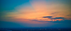 Orange and blue sunset over city lights