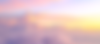 Pink and orange clouds from above at sunset