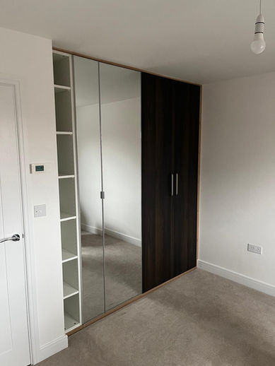 Custom fitted wardrobe with mirrored and panel doors, seamless built-in finish, modern home, Hassocks, Sussex