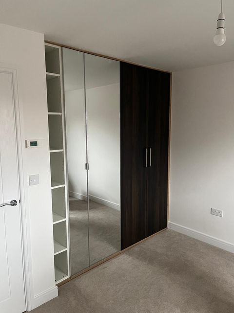 Custom fitted wardrobe with mirrored and panel doors, seamless built-in finish, modern home, Hassocks, Sussex