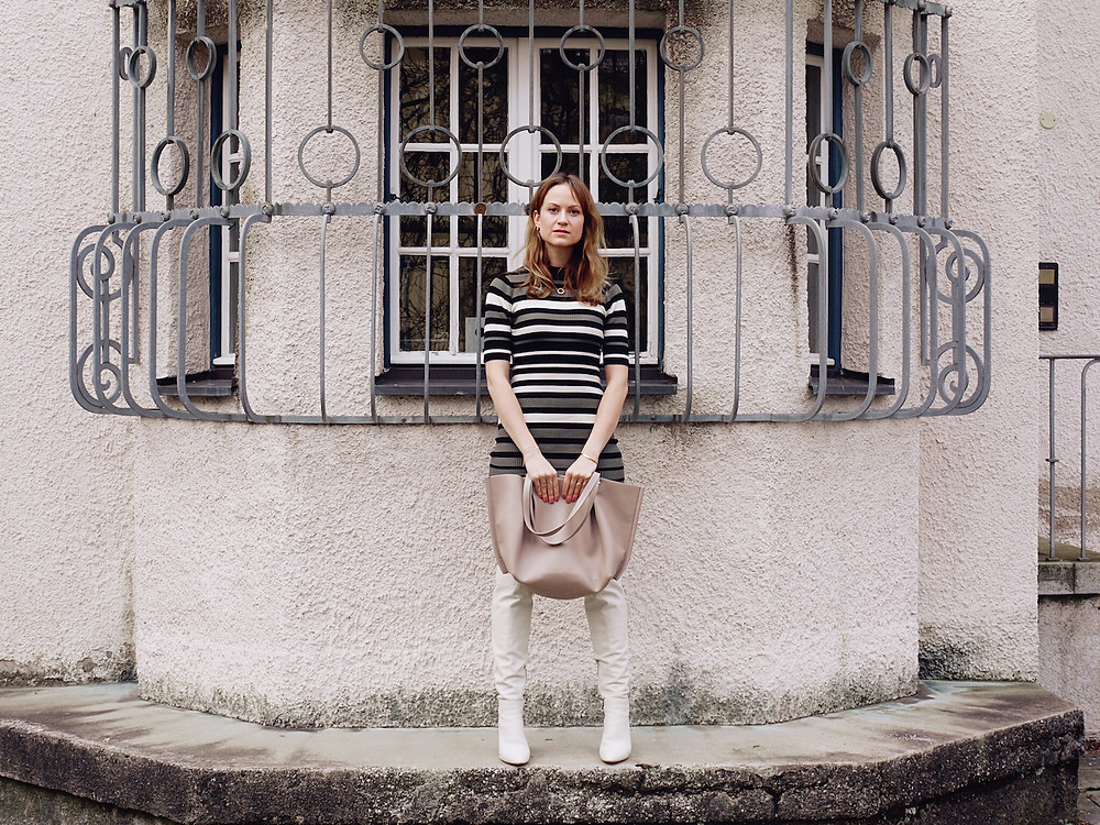 2020 fashion trends: outfit consisting of striped mini dress, white boots, big tote bag