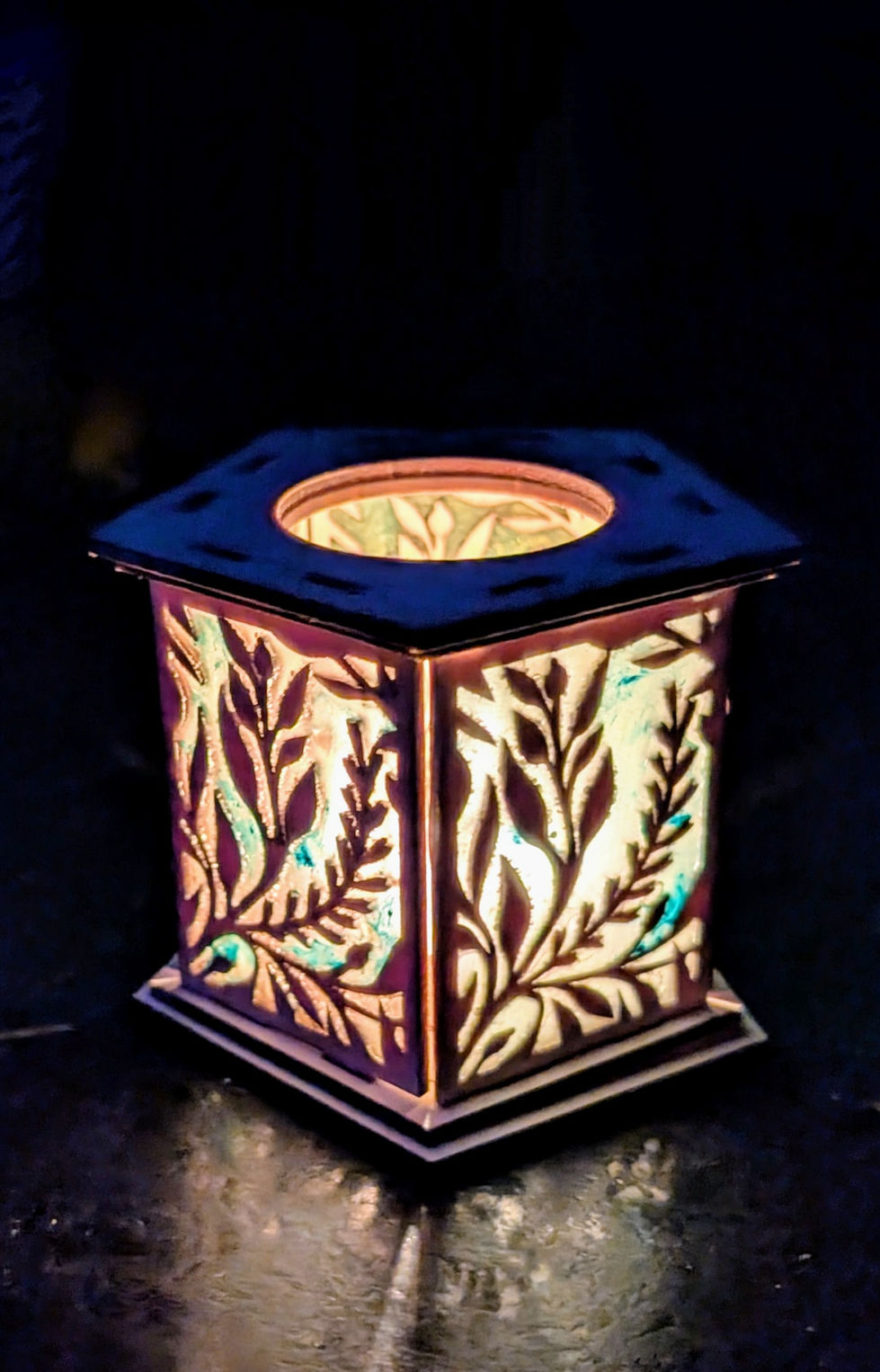 Tealight holder with resin infill creating coloured effects.
