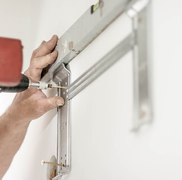 Image of someone installing shelves
