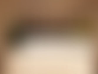 Ten wine bottle lineup from The Legends Dinner at La Paulée NYC 2025  with labels including Romanée-Conti and Montrachet are arranged on a round table with a white tablecloth in a softly lit room.