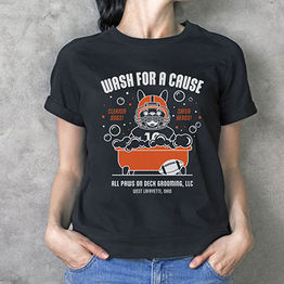 Woman wearing black t-shirt featuring a French Bulldog wearing a football helmet in the bathtub with bubbles floating in the air.