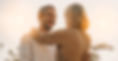 Man in 40s or 50s smiling as he hugs a woman.
