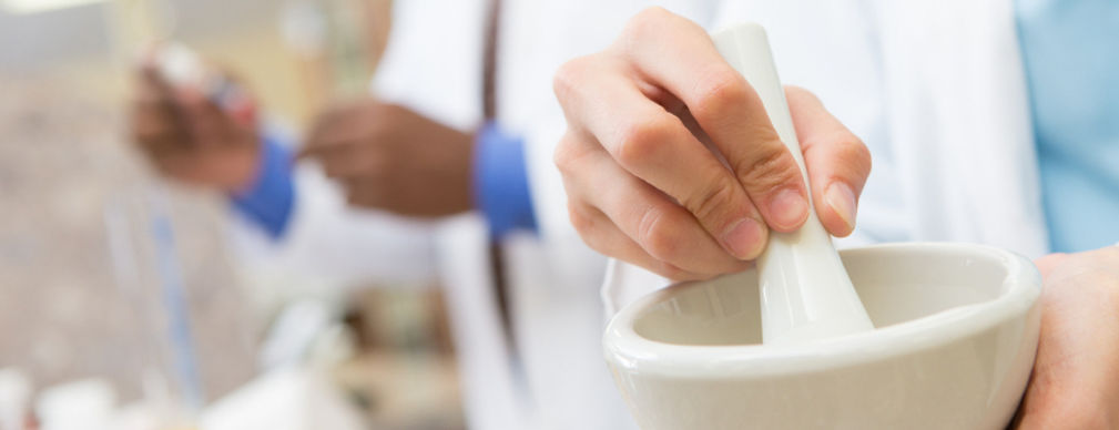Pharmacist using compounding lab mortar and pestle
