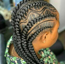 This is an alt text of a client with larger braids and small designs braided closely against the scalp.