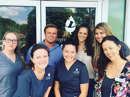 The staff at Riverside Village Pharmacy standing in front of the pharmacy.