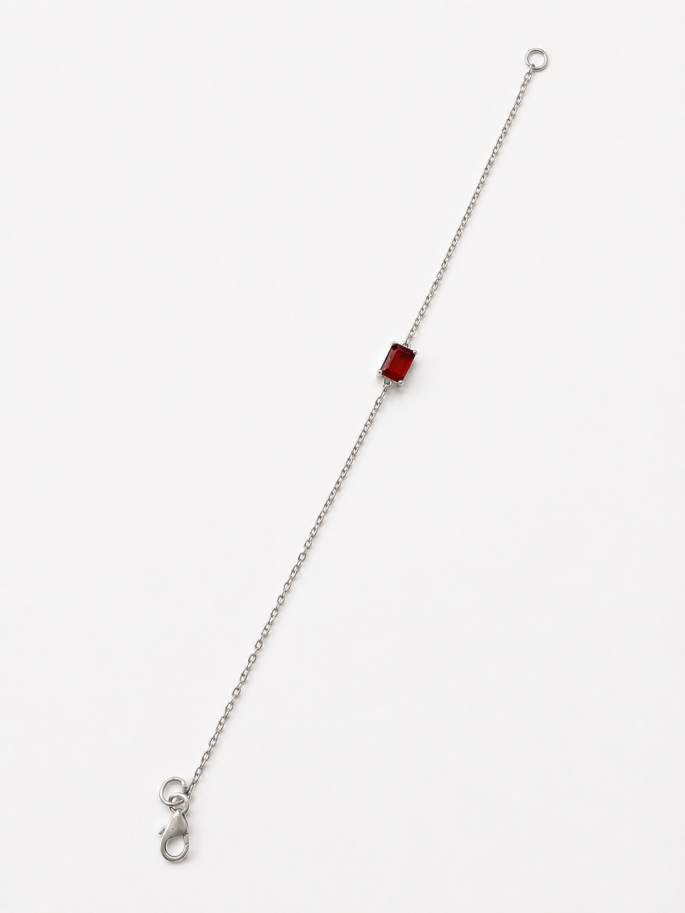 Thumbnail: Silver chain bracelet with a single emerald-cut red stone