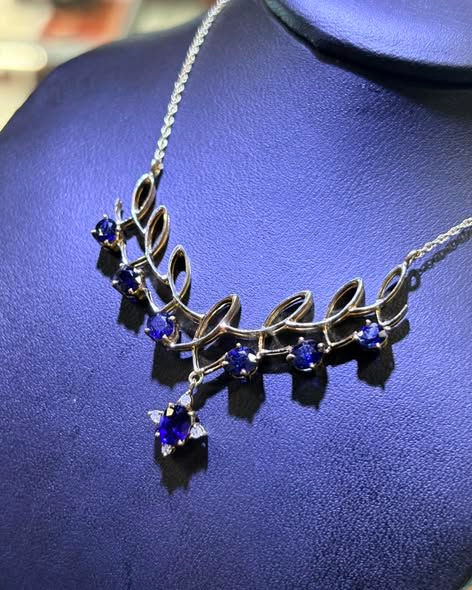 Thumbnail: Silver necklace with leaf designs and blue gemstones