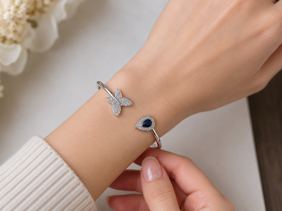 Sapphire and diamond butterfly cuff bracelet on a wrist