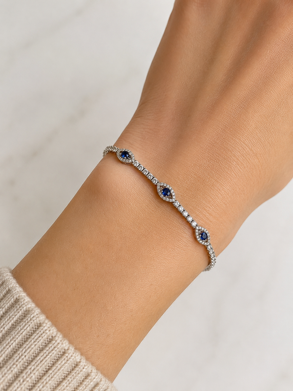 Marquise sapphire and diamond tennis bracelet on a wrist