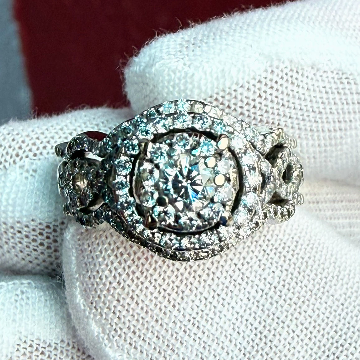 Top view of a natural round diamond wedding set in 14K white gold, with a double diamond halo and twisted pavé bands