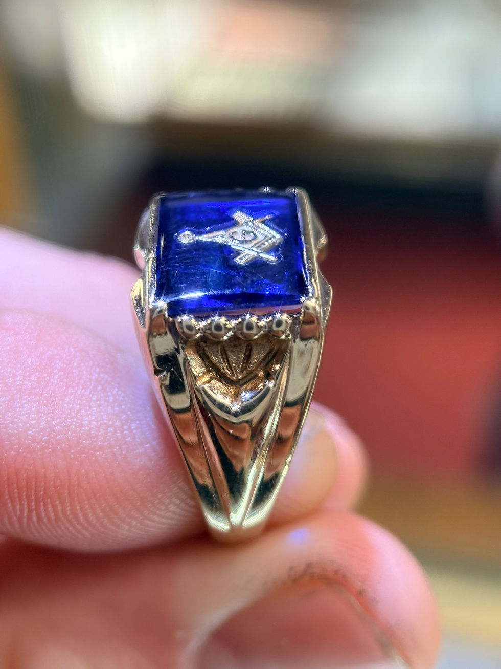 Thumbnail: Gold Masonic ring with blue stone and square and compass.