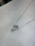 Thumbnail: Silver cross necklace with ornate detailing on a thin chain