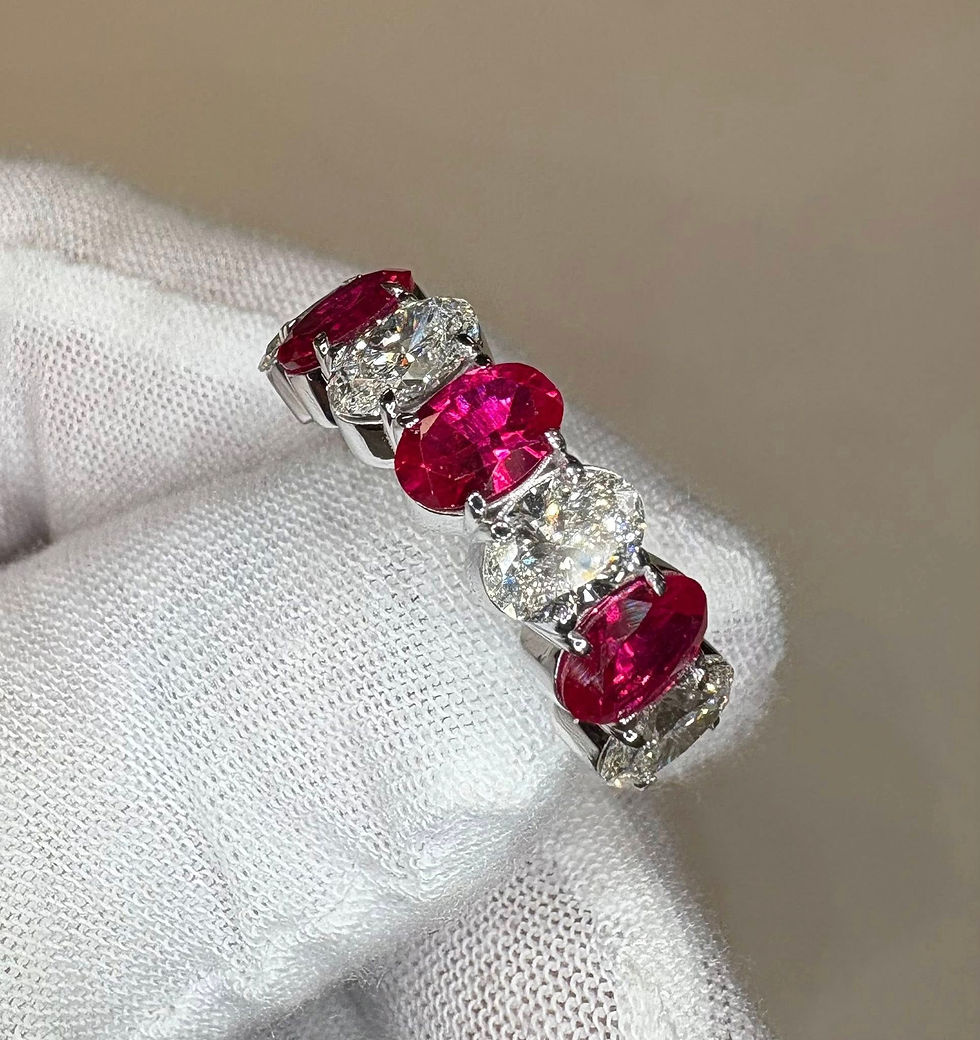 Thumbnail: Oval ruby and diamond band on a white gloved hand.