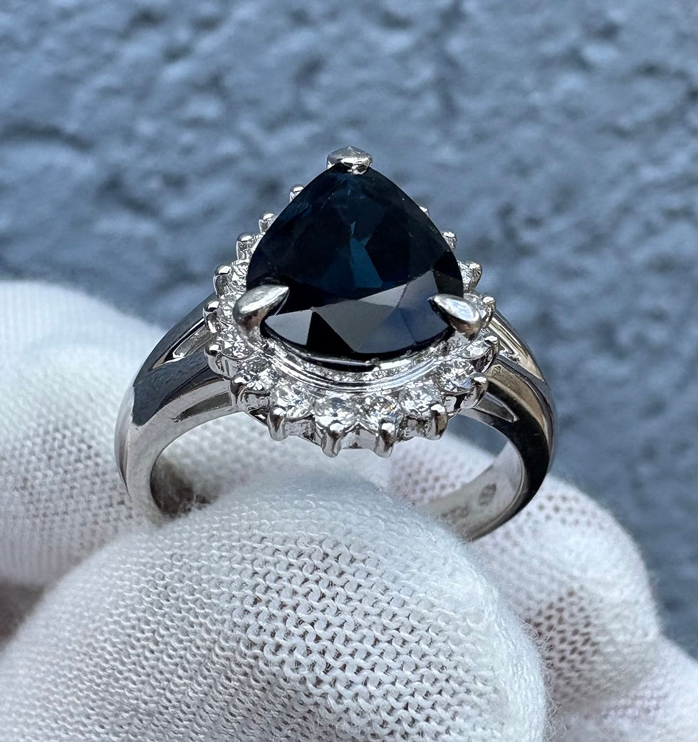 Thumbnail: Pear-cut dark blue sapphire ring with diamond halo