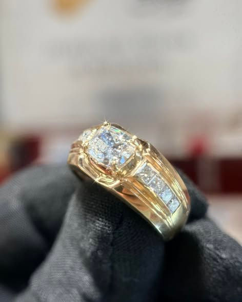 Thumbnail: Gold ring with diamonds on a black gloved hand
